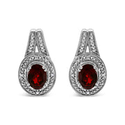Bids.com .925 Sterling Silver Diamond Accent and 8x6mm Red Oval Garnet Stud Earrings (I-J Color, I1-I2 Clarity) Earrings