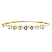 Bids.com 14K Yellow Gold Alternating Bezel Set 5MM Oval Shaped Tanzanite and 1/5 Cttw Diamond Bangle Bracelet (H-I Color, VS2-SI1 Clarity) - Fit's wrists up to 7.25" Inches Bracelets