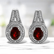 Bids.com .925 Sterling Silver Diamond Accent and 8x6mm Red Oval Garnet Stud Earrings (I-J Color, I1-I2 Clarity) Earrings