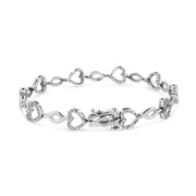 Bids.com .925 Sterling Silver 1/4 Cttw Round-Cut Diamond Alternating Heart and Leaf Link Bracelet (I-J Color, I3 Clarity) - Size 7.25" Bracelets