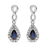 Bids.com 10K White Gold Pear Cut Blue Sapphire and 1/7 Cttw Diamond Infinity Drop and Dangle Earrings (I-J Color, I1-I2 Clarity) Earrings
