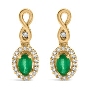 Bids.com 10K Yellow Gold Oval Cut Green Emerald 5x3 mm and 1/7 Cttw Round Diamond Dangle Earrings Earrings