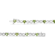 Bids.com .925 Sterling Silver 1.00 Cttw Diamond and 4.00mm Lab Created Green Heart-Shaped Peridot Infinity Link Bracelet (I-J Color, I2-I3 Clarity) - 7.25" Bracelets