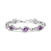 Bids.com .925 Sterling Silver 1/10 Cttw Natural Round Diamond and 7X5MM Oval Amethyst Cross Tennis Bracelet (I-J Color, I1-I2 Clarity) - 7" Bracelets