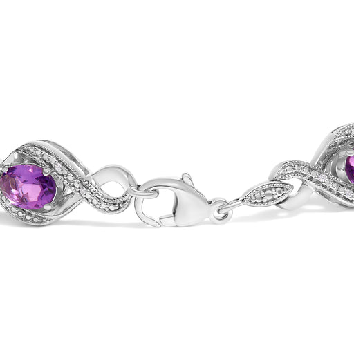 Bids.com .925 Sterling Silver 1/10 Cttw Natural Round Diamond and 7X5MM Oval Amethyst Cross Tennis Bracelet (I-J Color, I1-I2 Clarity) - 7" Bracelets