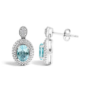 Bids.com .925 Sterling Silver Diamond Accent and  Oval Blue Topaz with Beaded Halo Drop Stud Earrings (I-J color, I1-I2 Clarity) Earrings