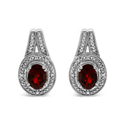 Bids.com .925 Sterling Silver Diamond Accent and 8x6mm Red Oval Garnet Stud Earrings (I-J Color, I1-I2 Clarity) Earrings
